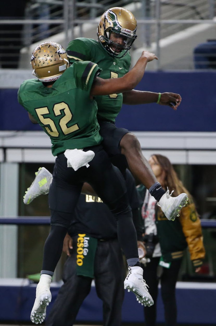 DeSoto quarterback Tristen Wallace (5) celebrates with offensive lineman Justice Womack (54)...