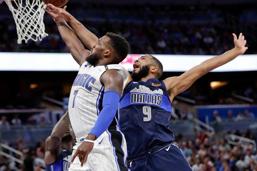 Orlando Magic's Shelvin Mack (7) goes to the basket past Dallas Mavericks' Aaron Harrison...