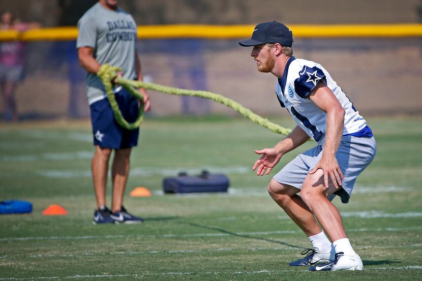 Dallas Cowboys wide receiver Cole Beasley works out with a resistance cord during the...