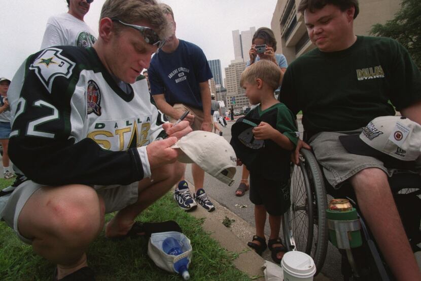 Brett Hull signs for young fans before the parade in downtown Dallas  Monday afternoon June...