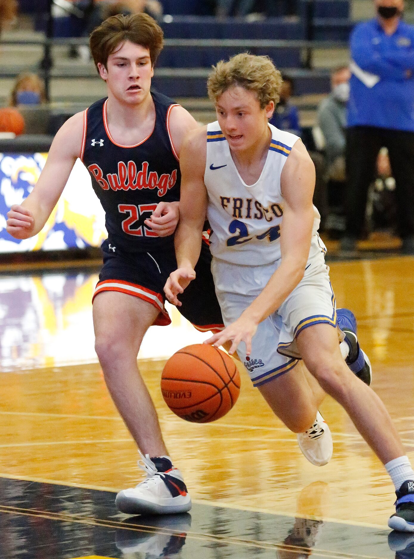 Frisco High School forward Rocco Paul (24) drives to the basket as McKinney North High...