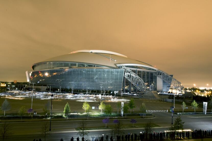 About 2,400 volunteers with flashlights and handheld flash units light up Cowboys Stadium...