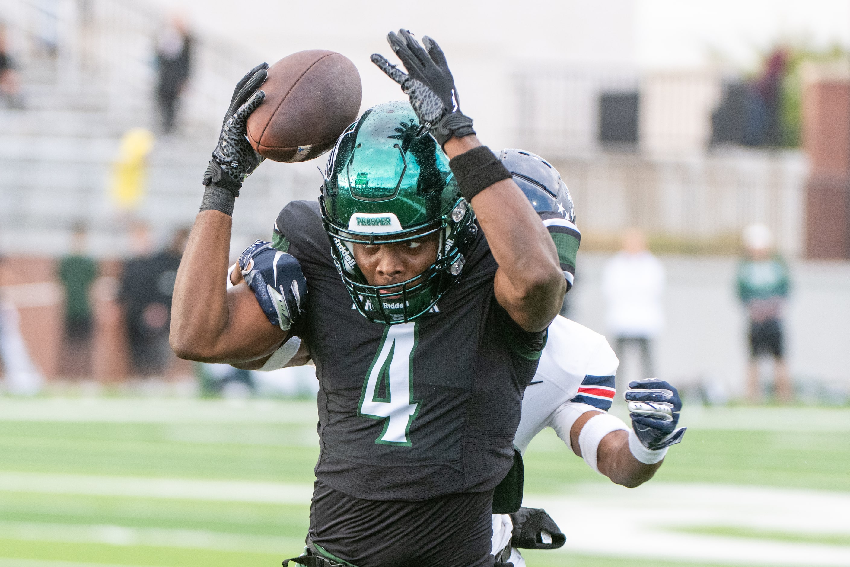 Prosper's Javan Henry (4) catches a pass in front of Allen’s Camden Clark (31) in the first...