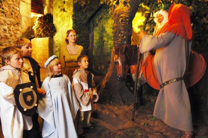 
A group of children in medieval costumes visit the Canterbury Tales audiovisual show at St....