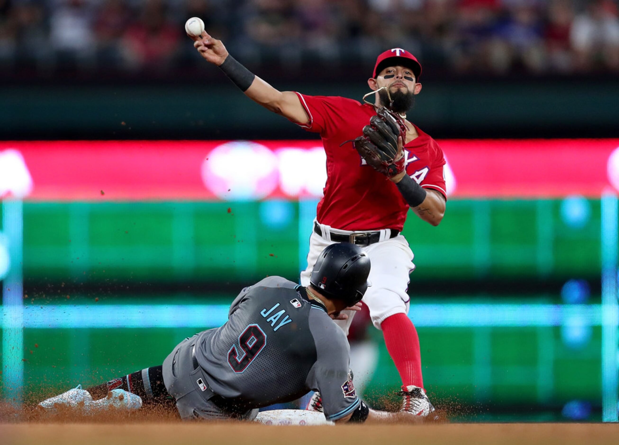 ARLINGTON, TX - AUGUST 14:  Rougned Odor #12 of the Texas Rangers turns a double play...