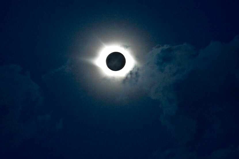 FILE - A total solar eclipse is observed above the mountainous Siberian Altai region, about...