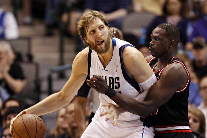 Dallas Mavericks power forward Dirk Nowitzki (left) works against former Chicago Bulls small...
