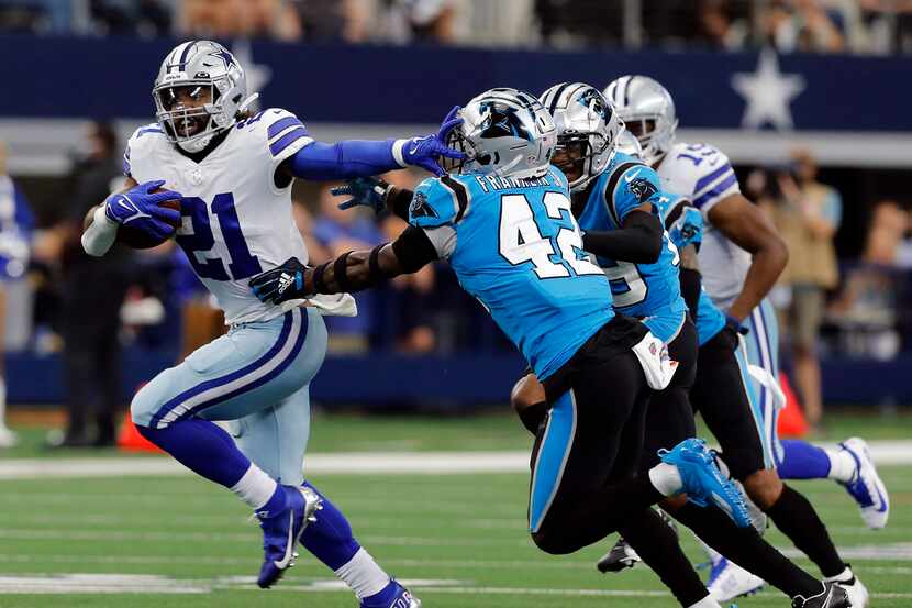 Dallas Cowboys running back Ezekiel Elliott (21) straightarms Carolina Panthers safety Sam...