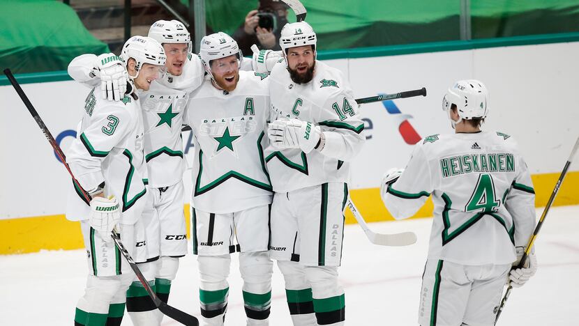 Dallas Stars forward Roope Hintz, second from left, is congratulated by teammates after...