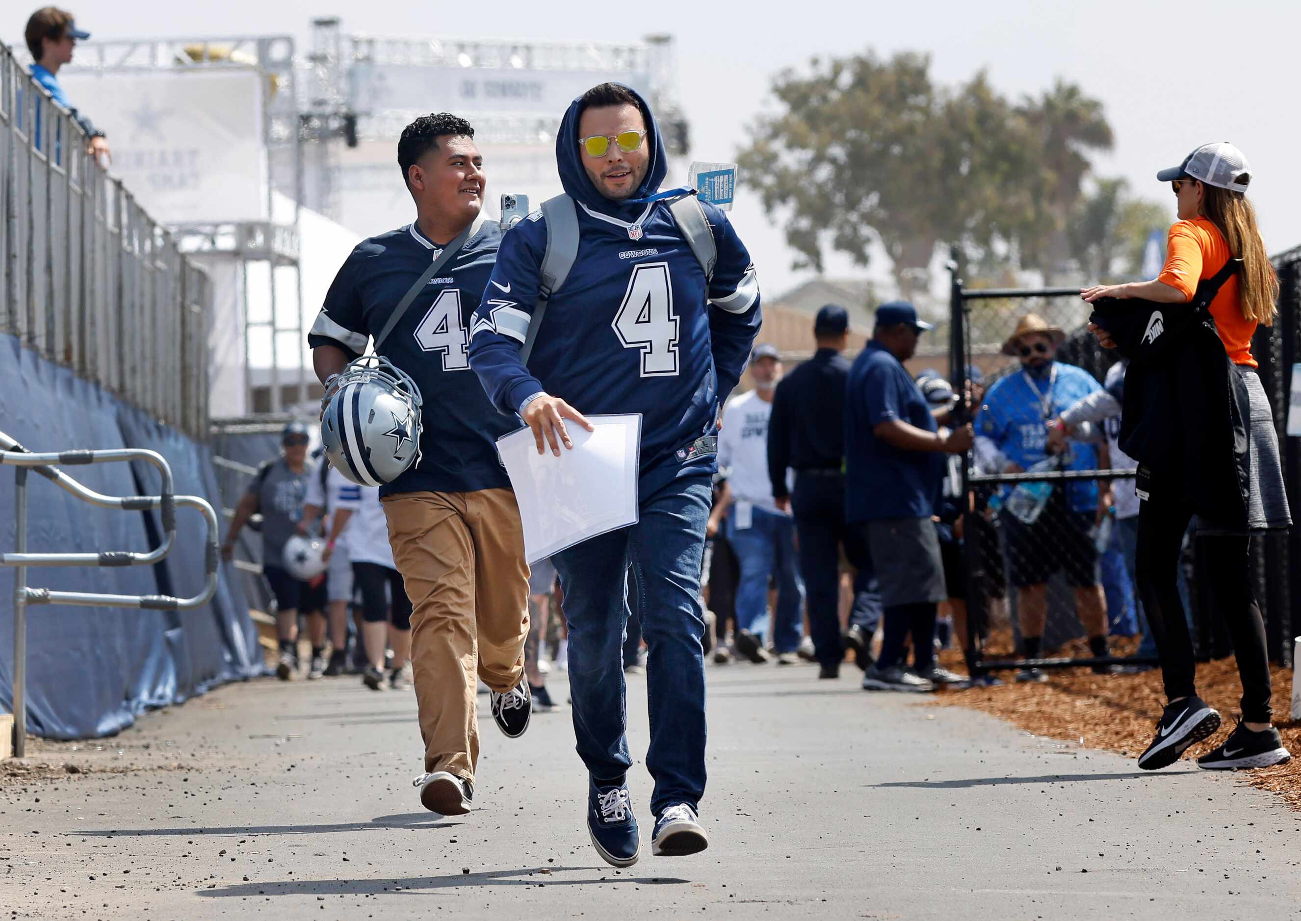 Dallas Cowboys fans run to secure a front row spot to watch the first 2022 Dallas Cowboys...