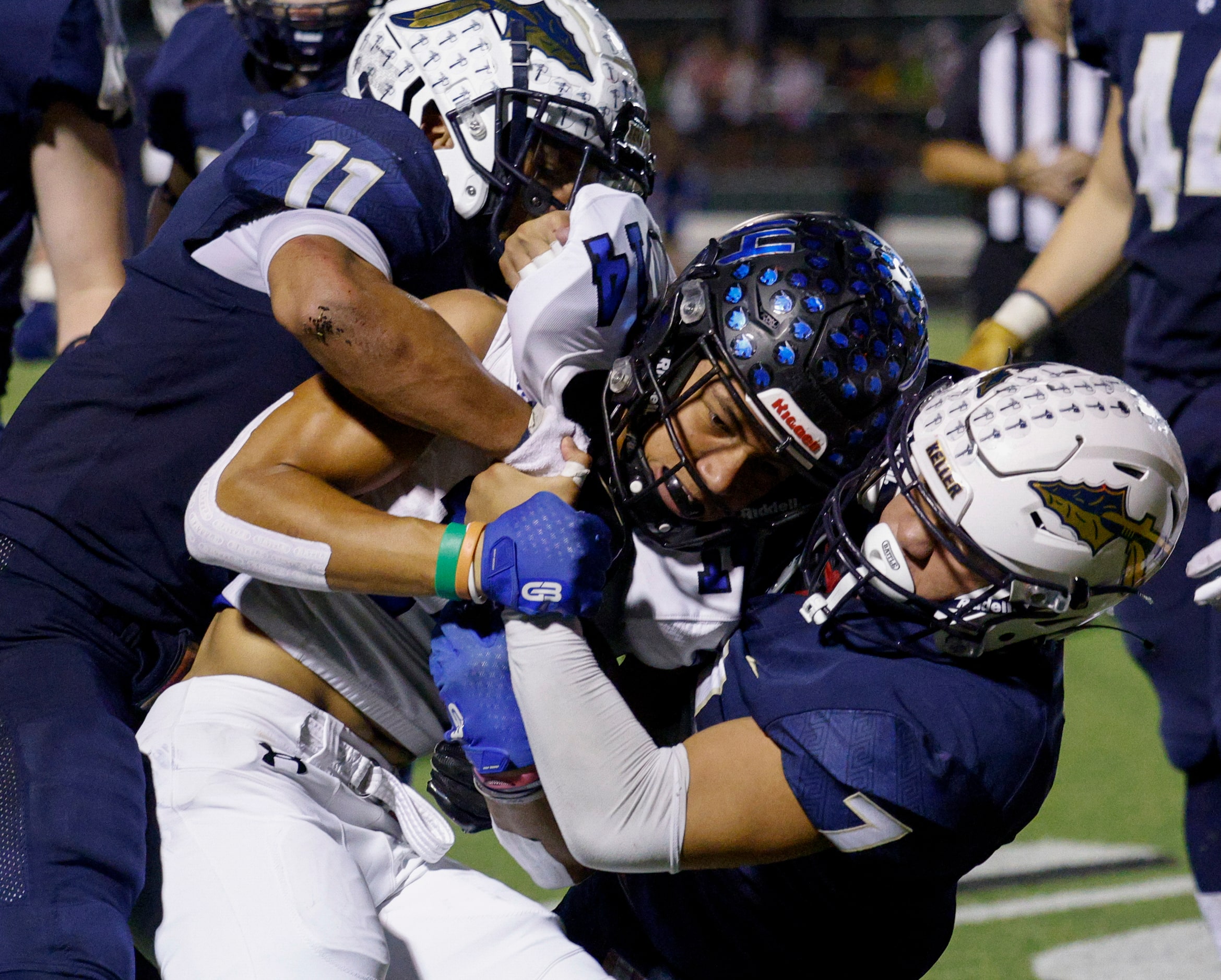 Keller defensive backs Amarion Henry (11) and Ryan Ventura (7) tackle Trophy Club Byron...