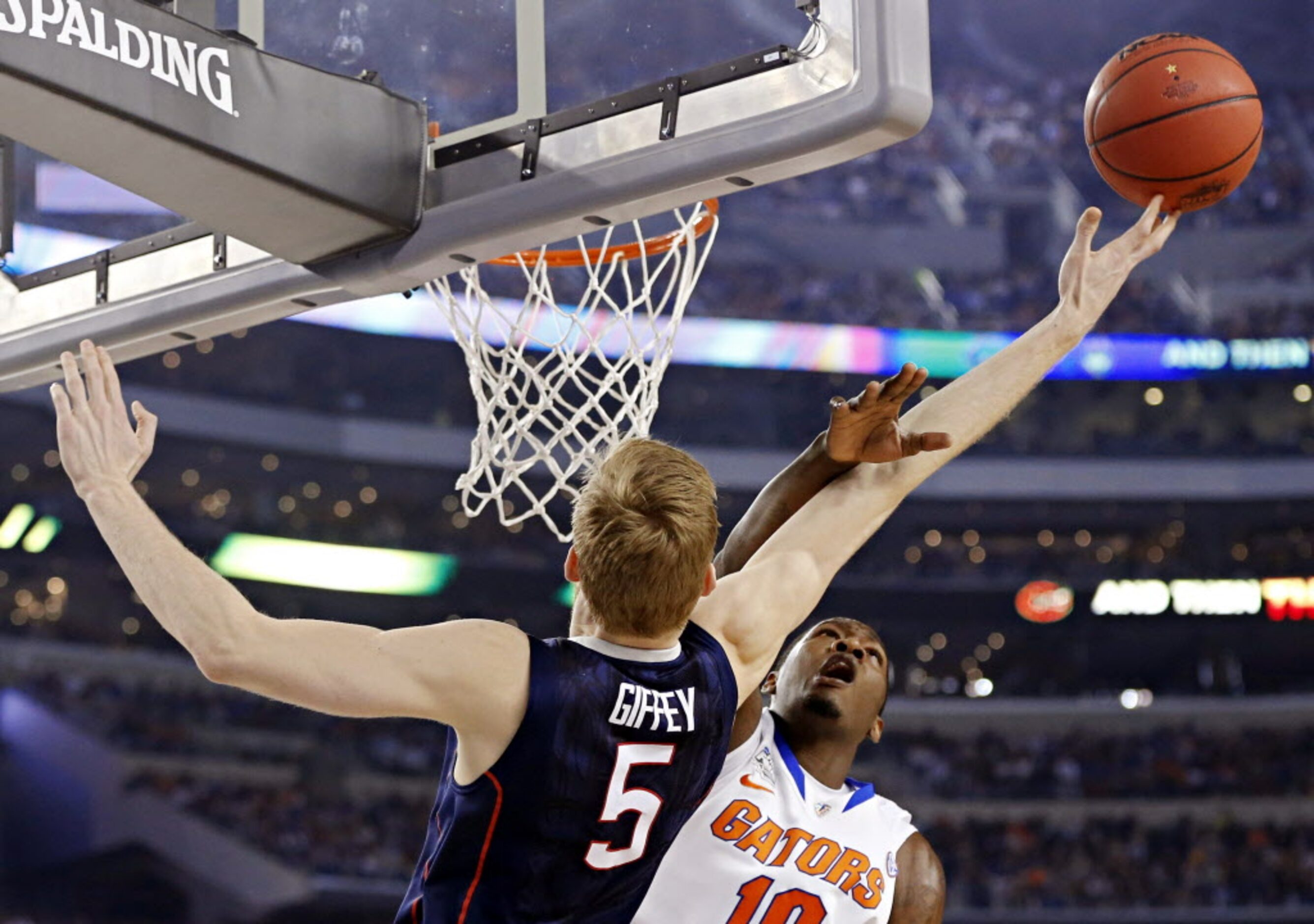 Florida Gators forward Dorian Finney-Smith (10) defends Connecticut Huskies guard/forward...