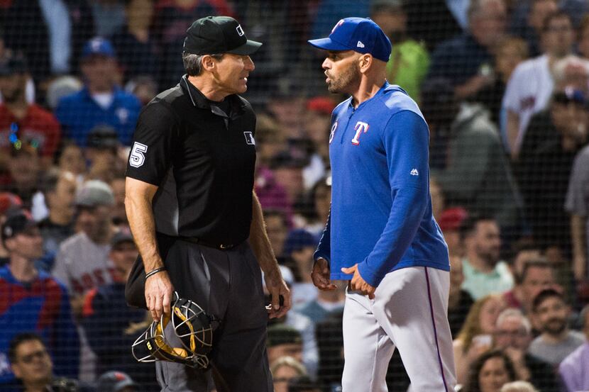 BOSTON, MA - JUNE 11:  Texas Rangers manager Chris Woodward #8 argues with home plate umpire...