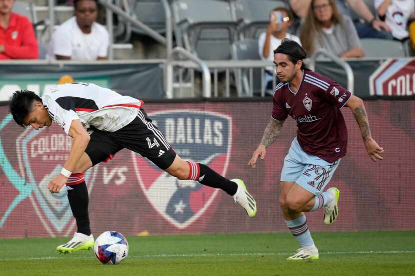 FC Dallas defender Marco Farfan, left, struggles to collect the ball as Colorado Rapids...
