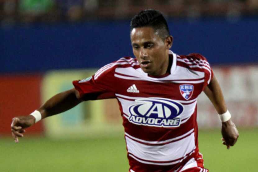 FC Dallas defender Eric Hassli (29) points to teammate Michel (31) at the corner after his...