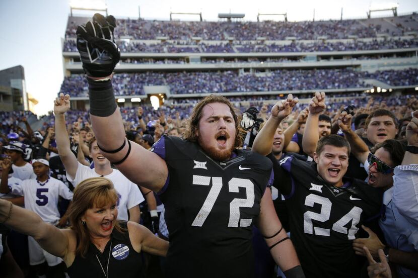 TCU Horned Frogs guard Bobby Thompson (72) and  place kicker Ryan DeNucci (24) celebrate...