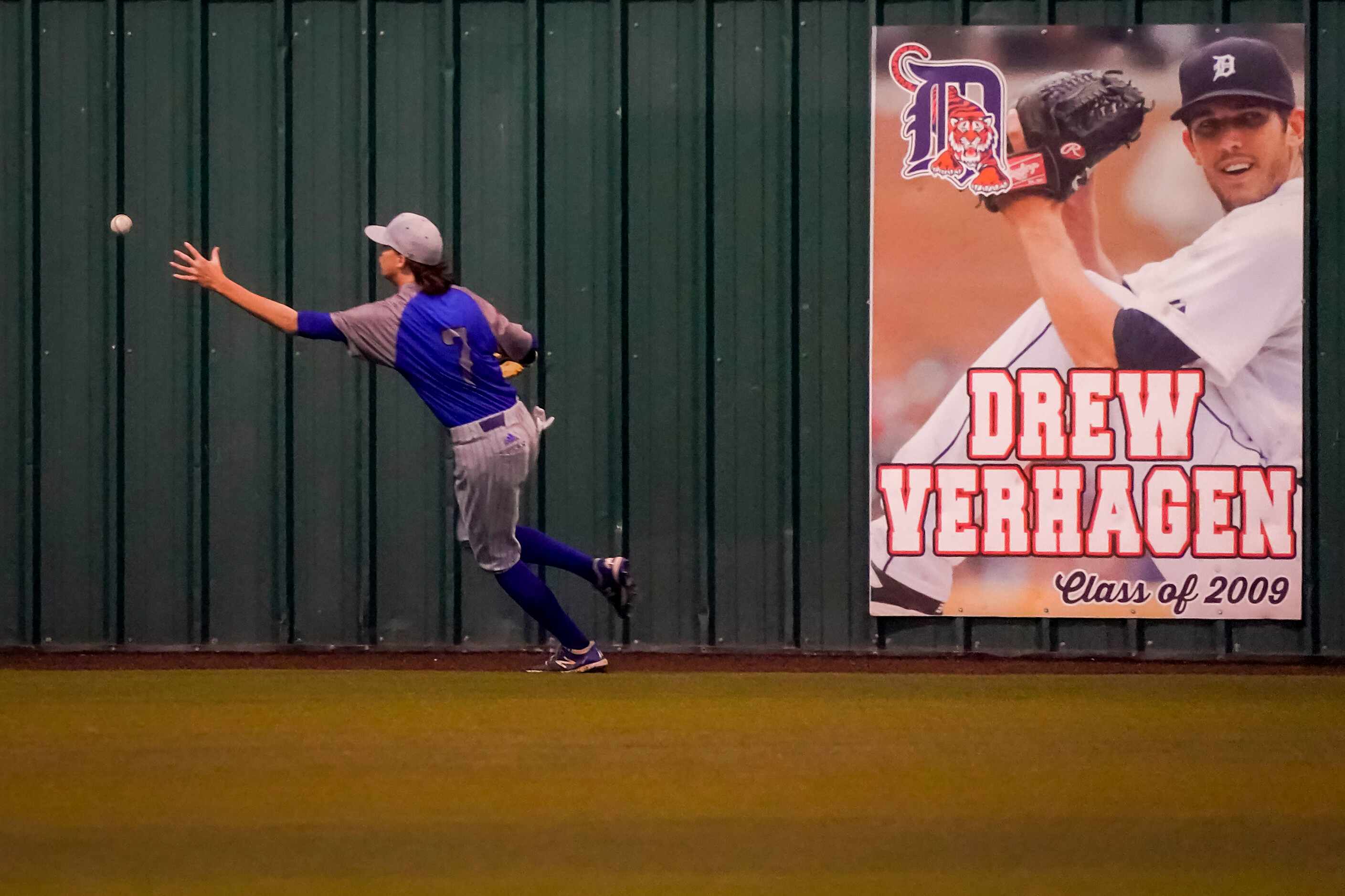 North Mesquite left fielder Christian Hinkle chases a double off the bat of Rockwall-Heath...
