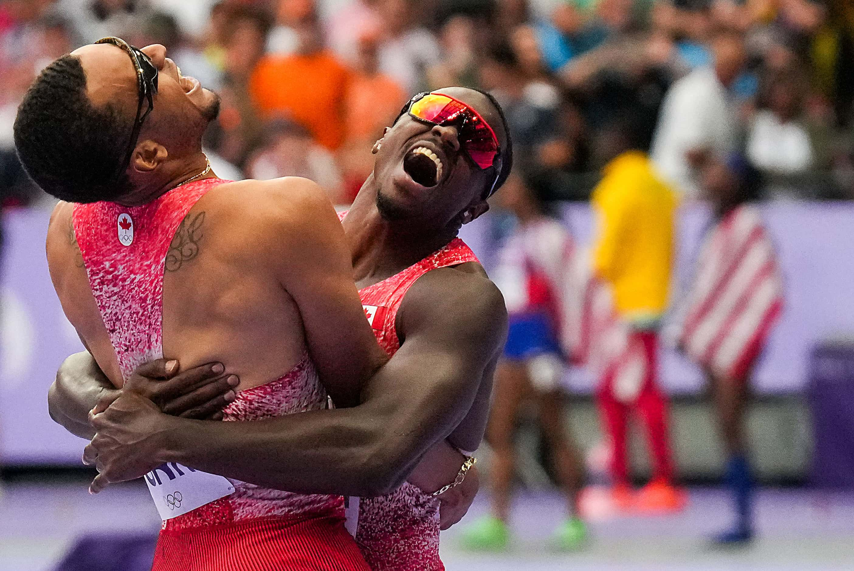 Aaron Brown (right) and Andre De Grasse of Canada celebrate after winning the final of the...