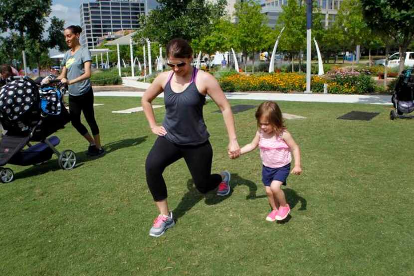 
Hannah Miller, 22 months, tries to mimic the moves of her mother, Stephanie Miller, during...