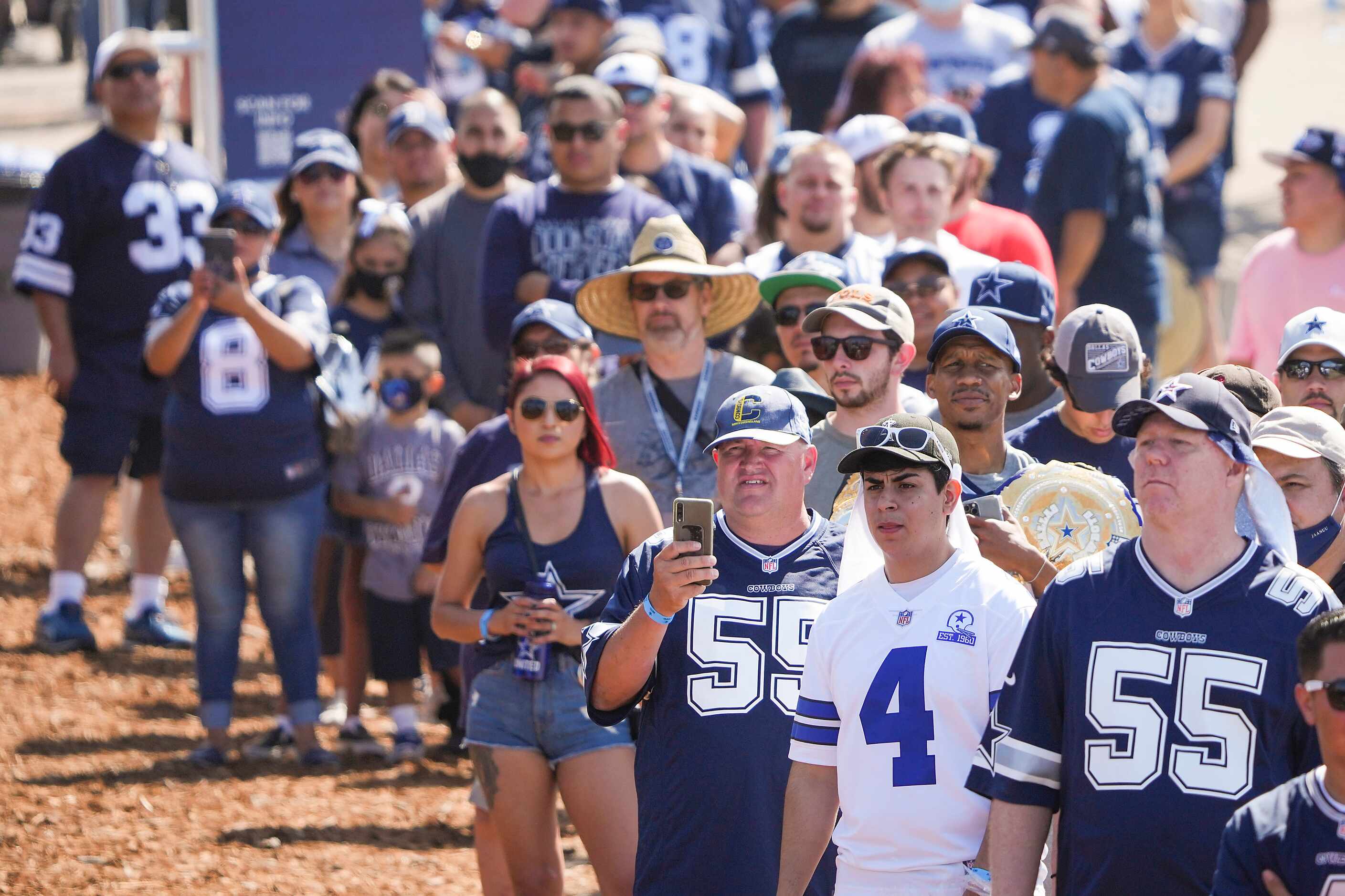 Fans wait for the gates to open before the first practice of the Dallas Cowboys training...