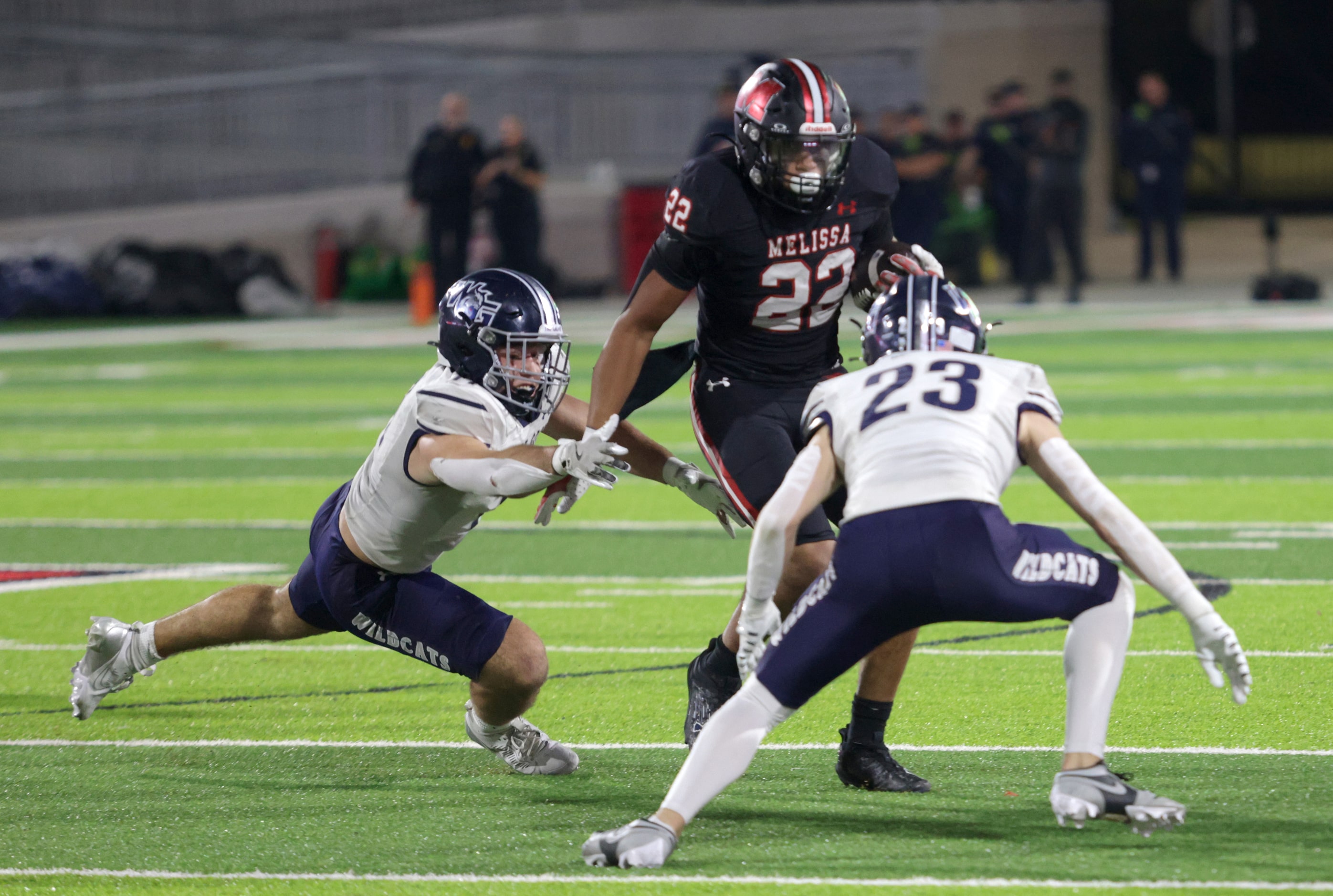 Melissa player #22 Jeremiah Tabor attempts to outmaneuver Walnut Grove players #11 Keller...