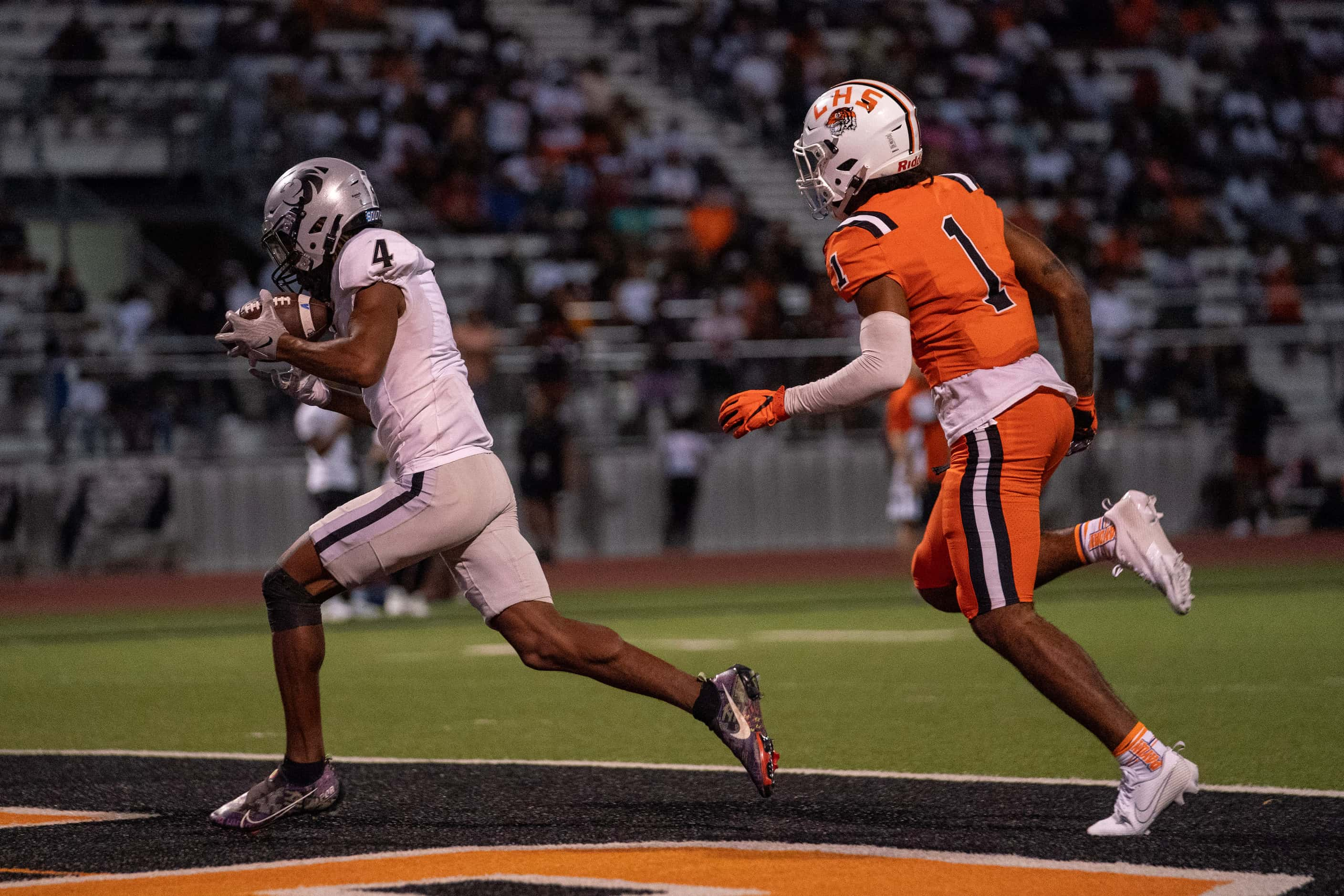 Denton Guyer senior wide receiver Josiah Martin (4) hauls in a touchdown pass in front of...