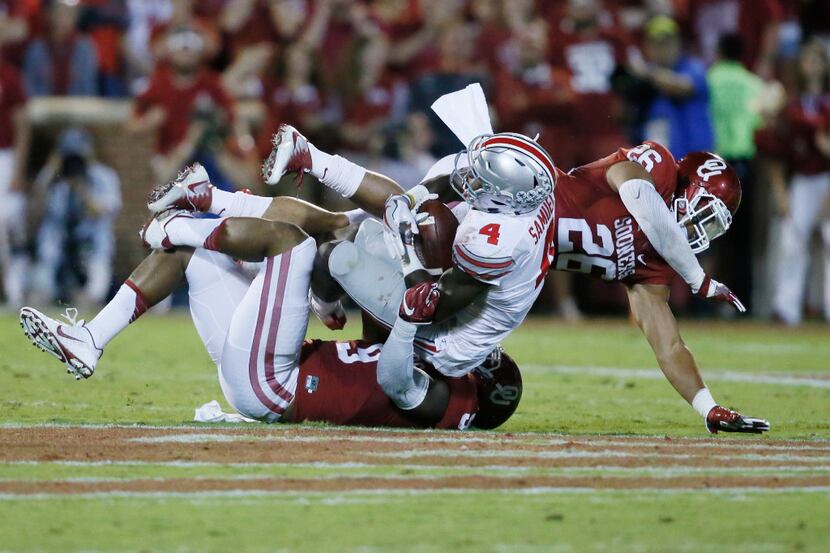 Ohio State running back Curtis Samuel (4) is tackled by Oklahoma linebacker Tay Evans,...