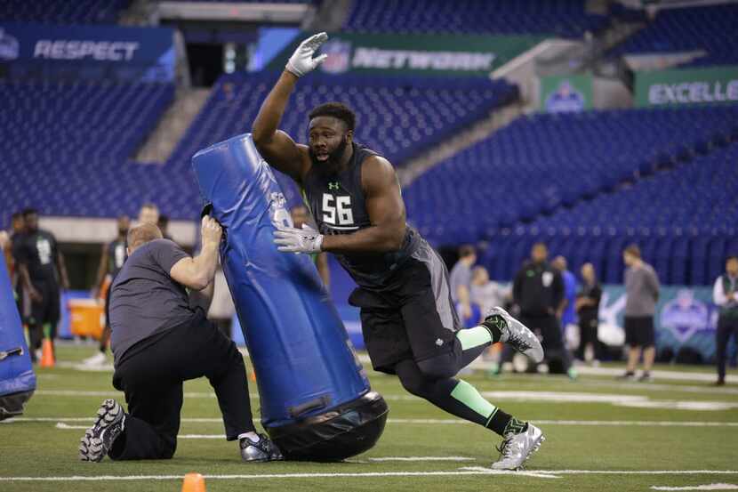 Oklahoma defensive lineman Charles Tapper runs a drill at the NFL football scouting combine...