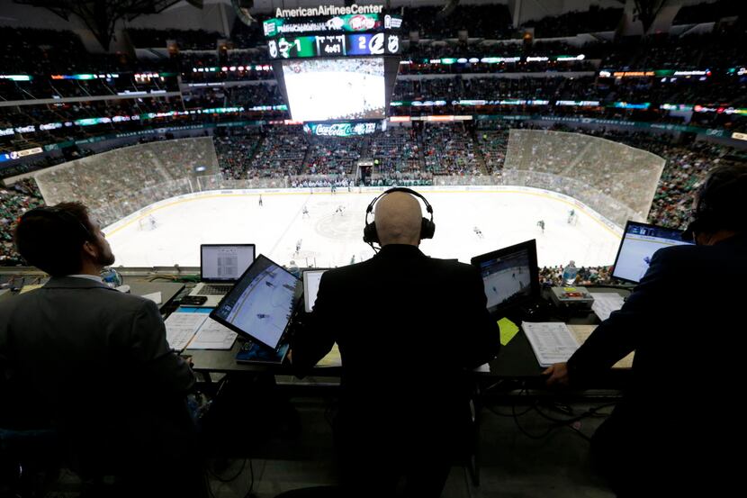 Dallas Stars play-by-play Dave Strader at work during the first period of play in a game...
