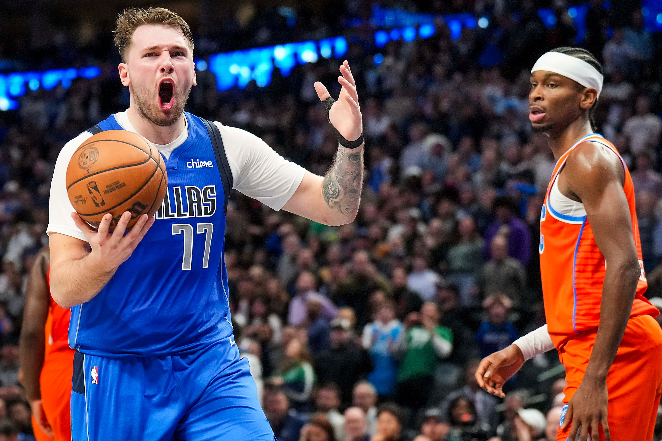 Dallas Mavericks guard Luka Doncic reacts after being called for traveling with 1:27 left in...