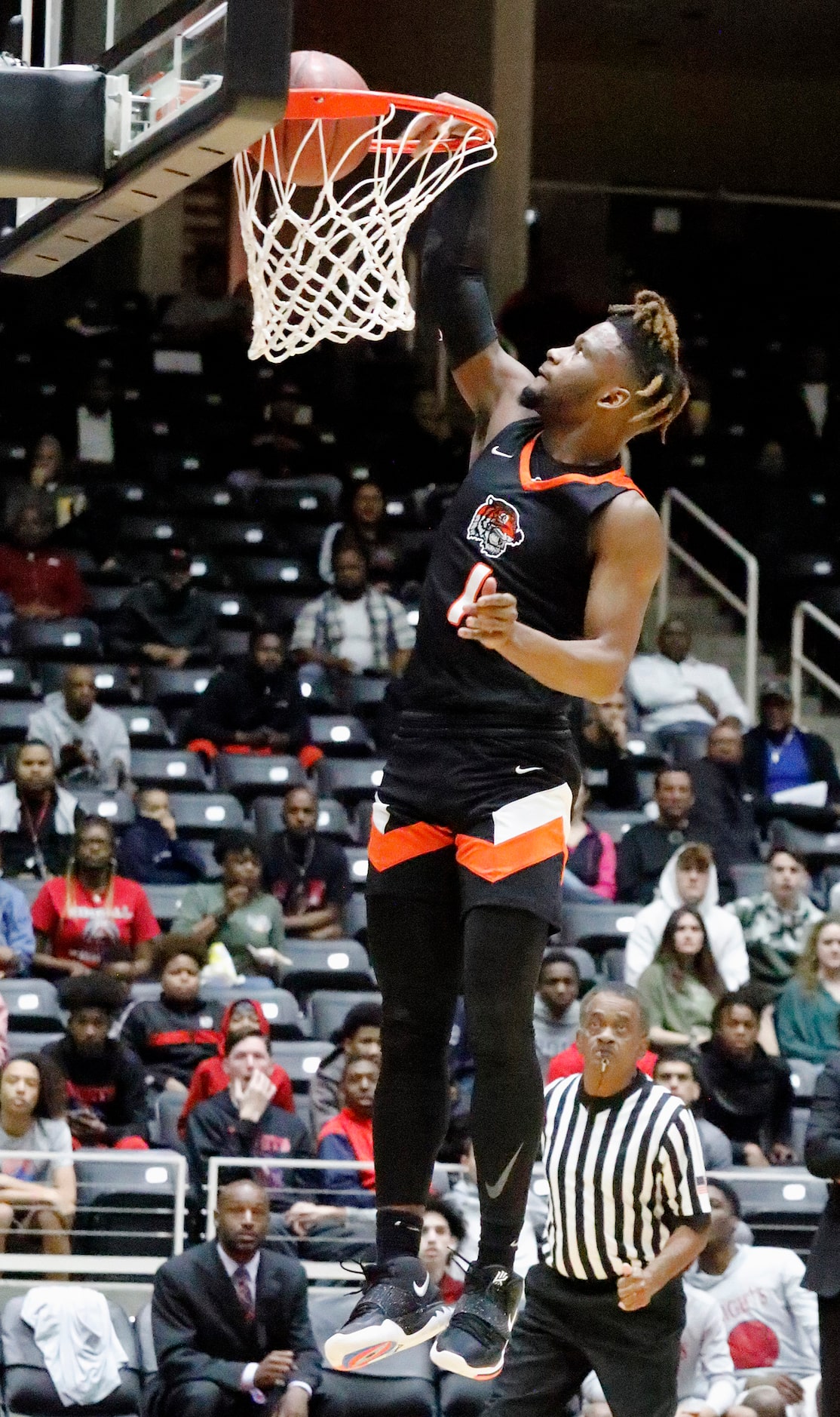 Lancaster High School guard Mike Miles (1) dunks the basketball during the first half as...