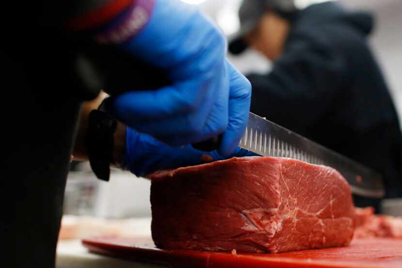 In this file photo, competitors cut sirloin. Frisco's new Wild Fork Foods offers more than...