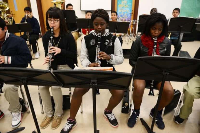 
Clarinet players (from left) Andrea Sanchez, Tityana Hashaway and Jada London play their...
