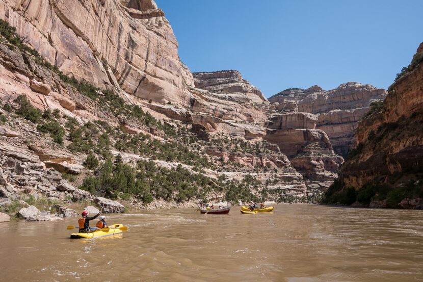 Rafts and duckies float the Yampa through Dinosaur National Monument.  The sandstone walls...