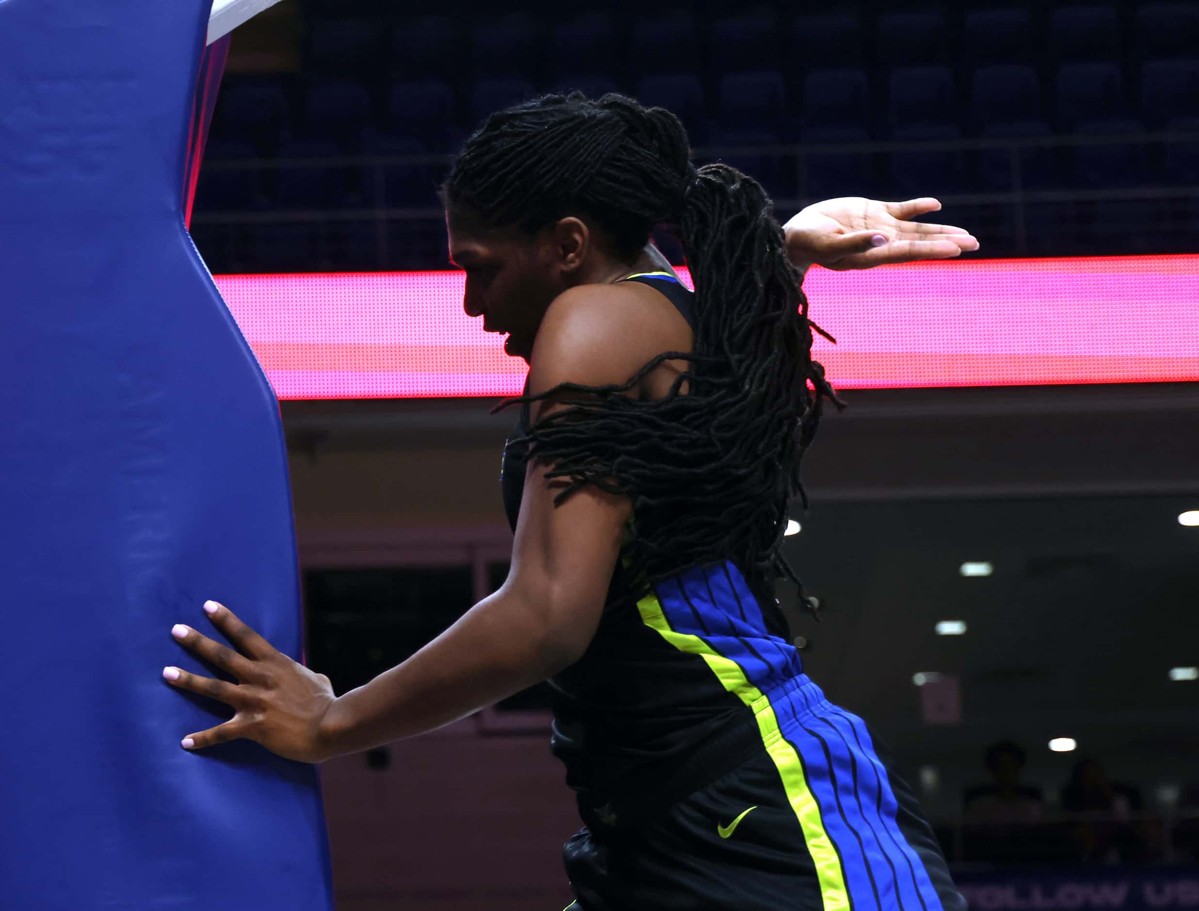 Dallas Wings center Teaira McCowan (7) slaps the padded basket support after missing a shot...