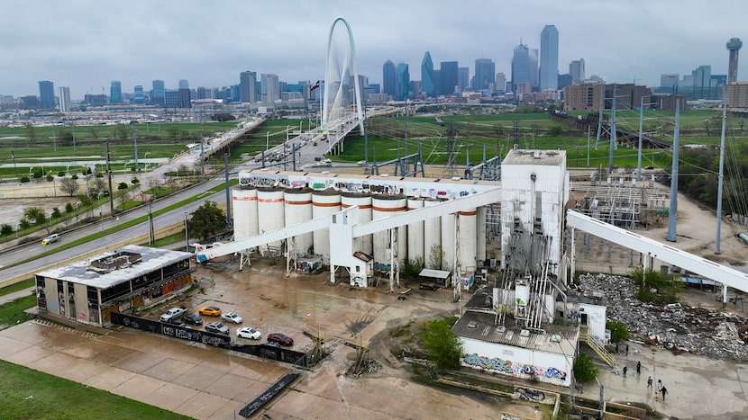 The Margaret Hunt Hill Bridge and downtown skyline rise over a properties that recently sold...