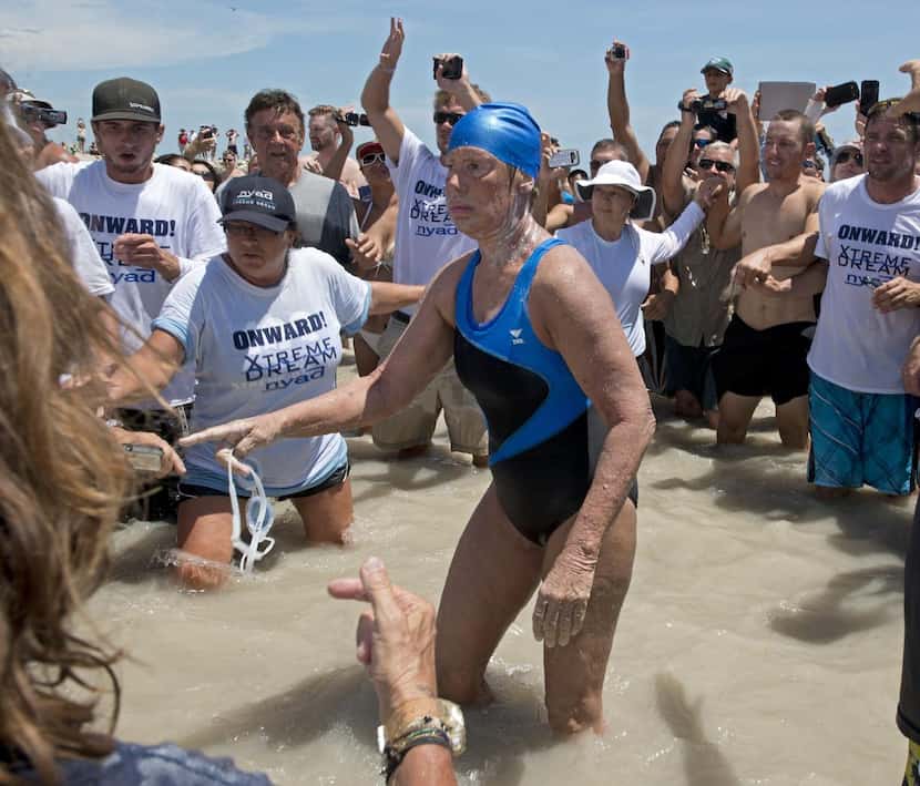 
Diana Nyad, then 64, emerges from the water in 2013 after completing her swim from Cuba to...