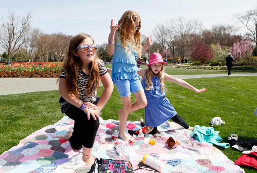 Alexis Dwyer, 8, Isabella Kelley, 9, and Lilly Kelley, 7, excitedly stand up for a game of...