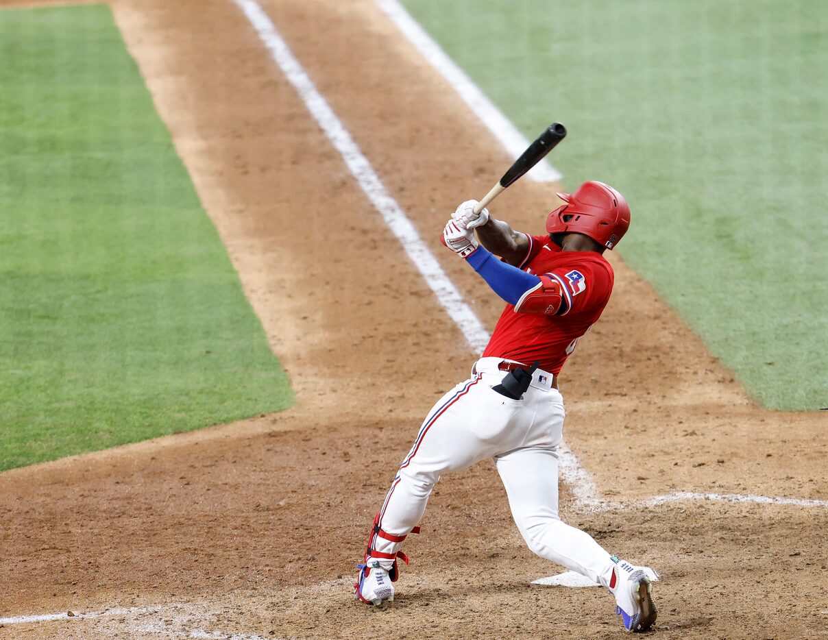 Texas Rangers batter Adolis Garcia (right) connects on a walk off 3-run homer in the tenth...