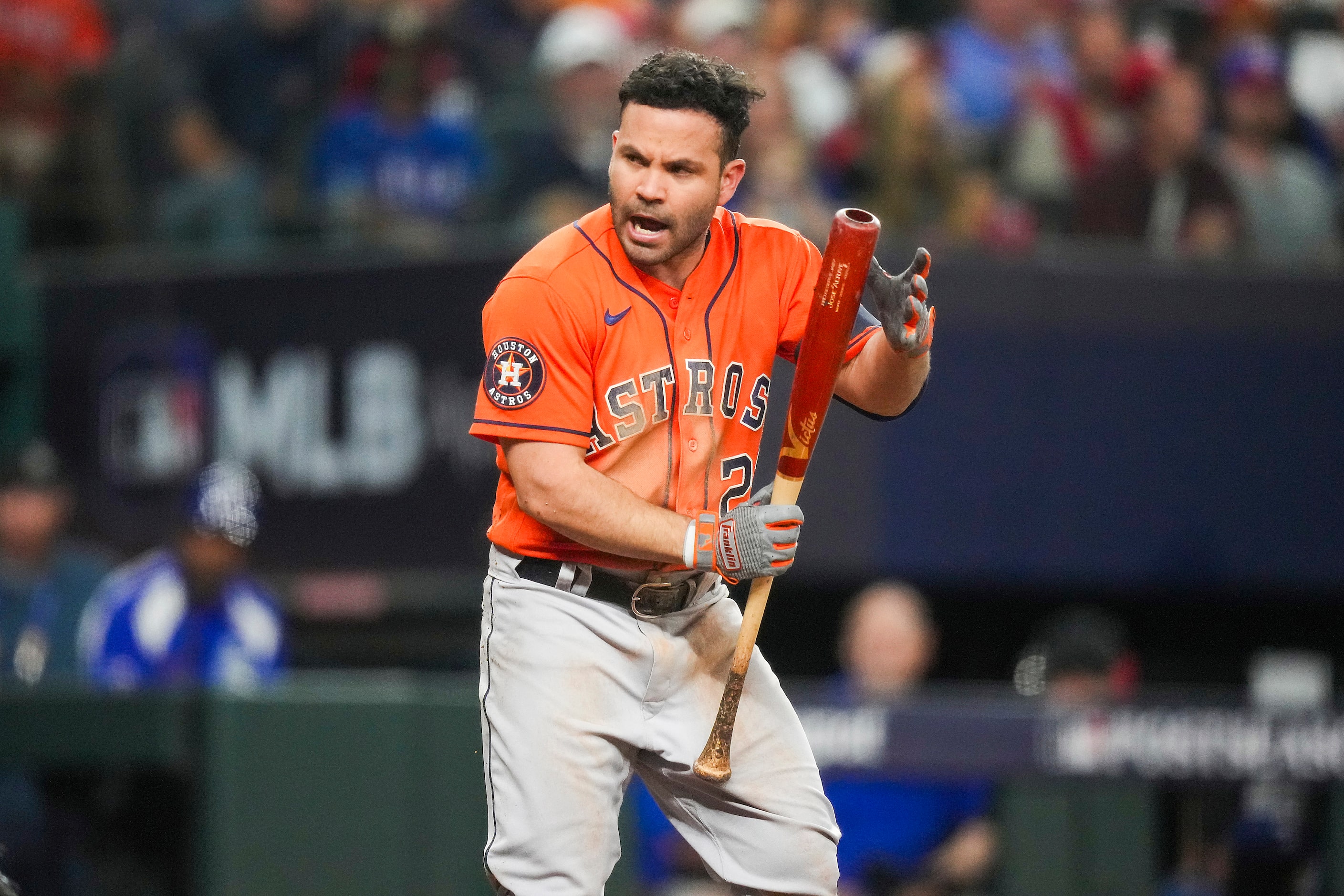 Houston Astros second baseman Jose Altuve reacts after getting brushed back by a pitch...