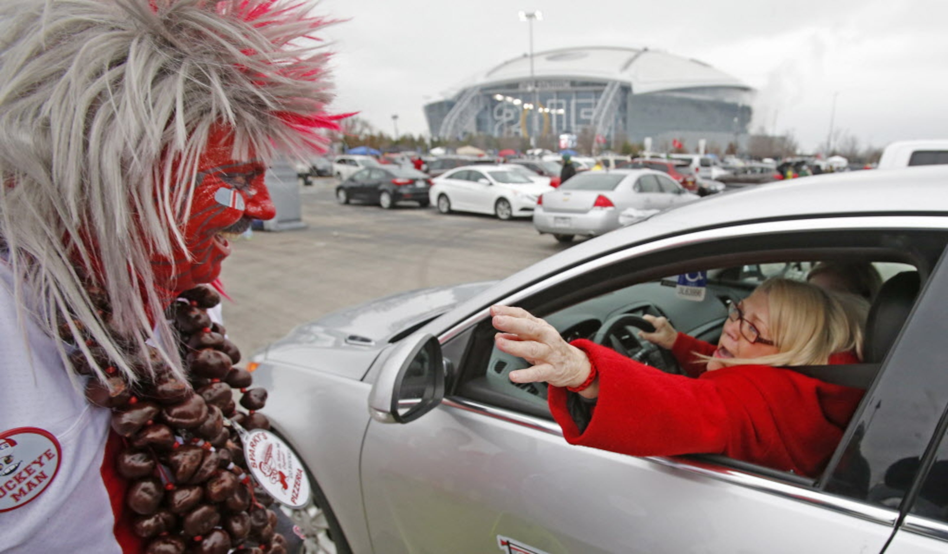 Larry Buckeyeman Lokai is greeted by a friend who just arrives at the game to tailgate...