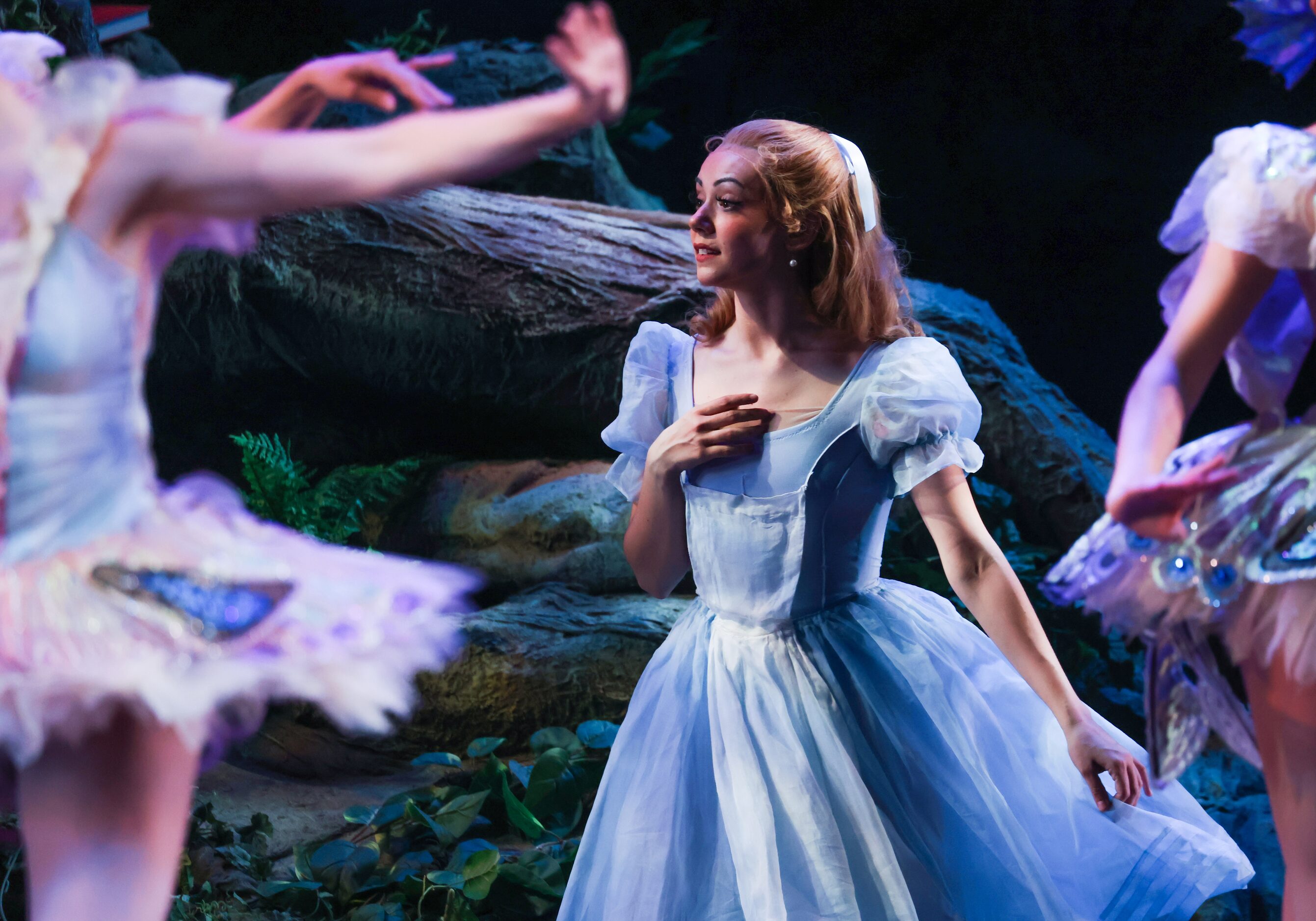 Alice (Alexandra F. Light, center) admires a swarm of butterflies and dragonflies after...