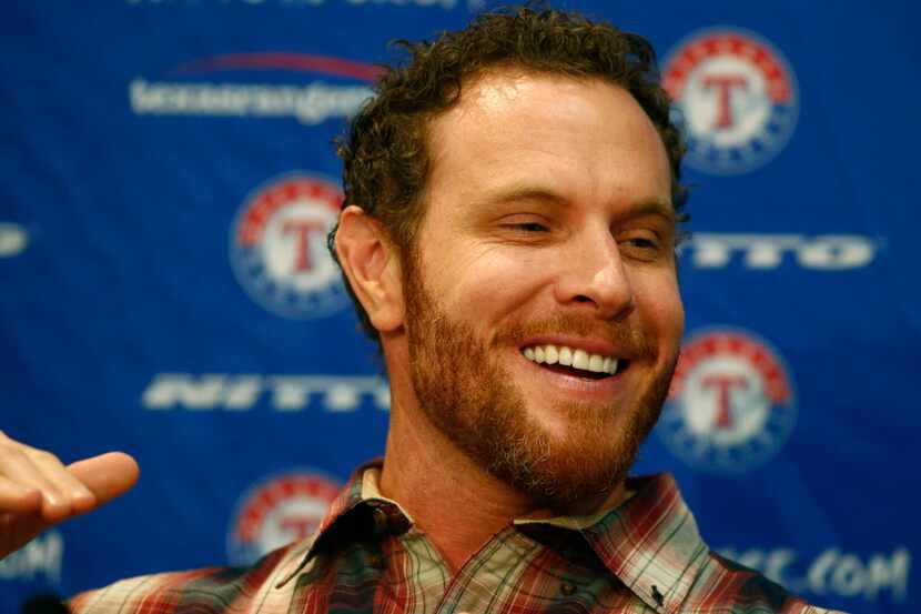 Josh Hamilton reacts as he talks about playing with the Texas Rangers again during a press...