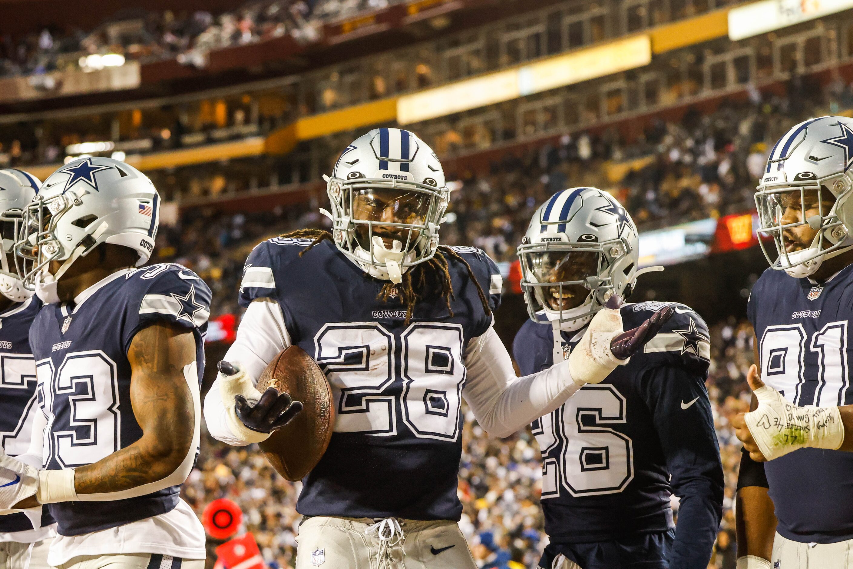 Dallas Cowboys wide receiver CeeDee Lamb (88) celebrates an interception with his teammates...