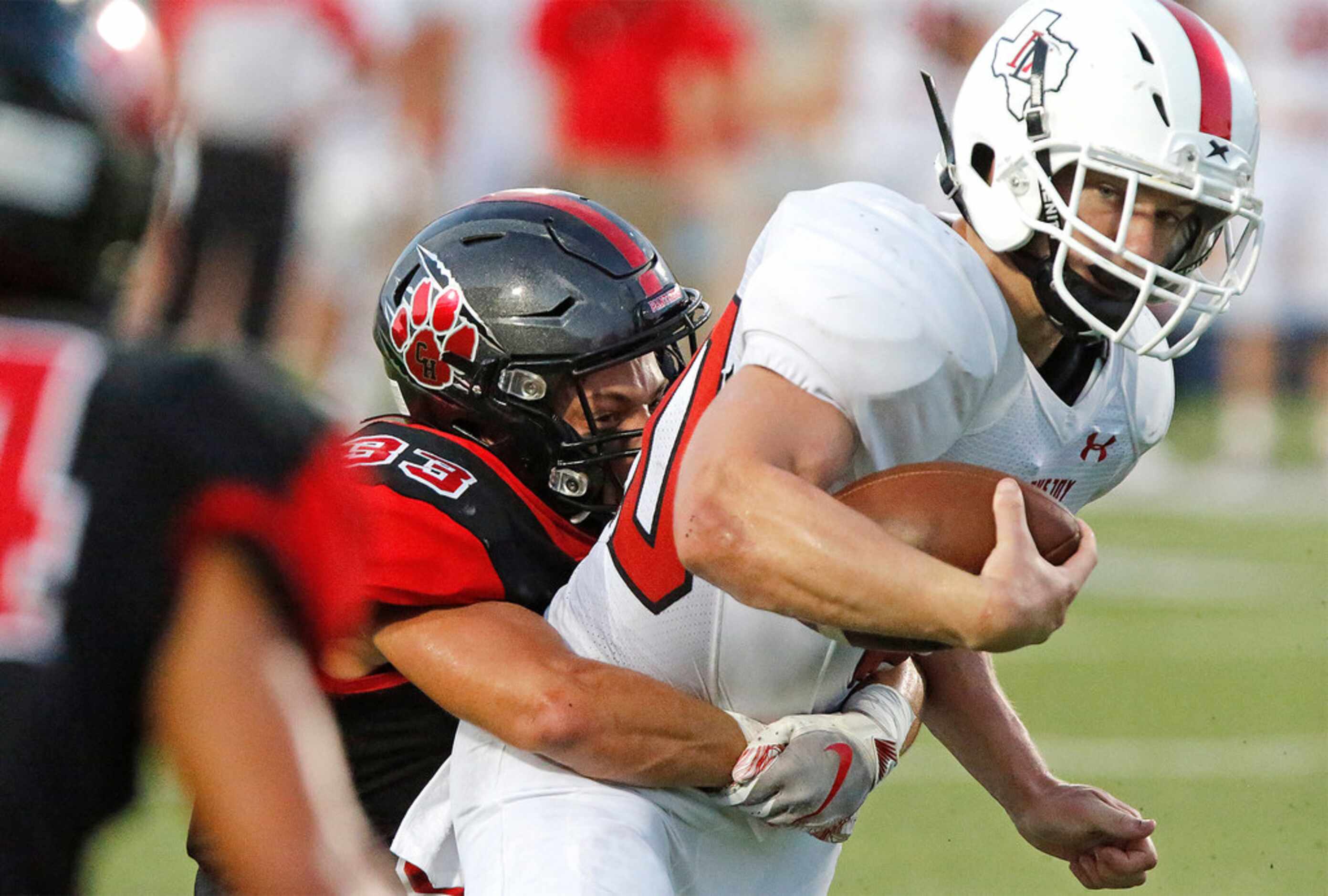 Lovejoy High School running back Austin King (20) looks at defenders closing in as...