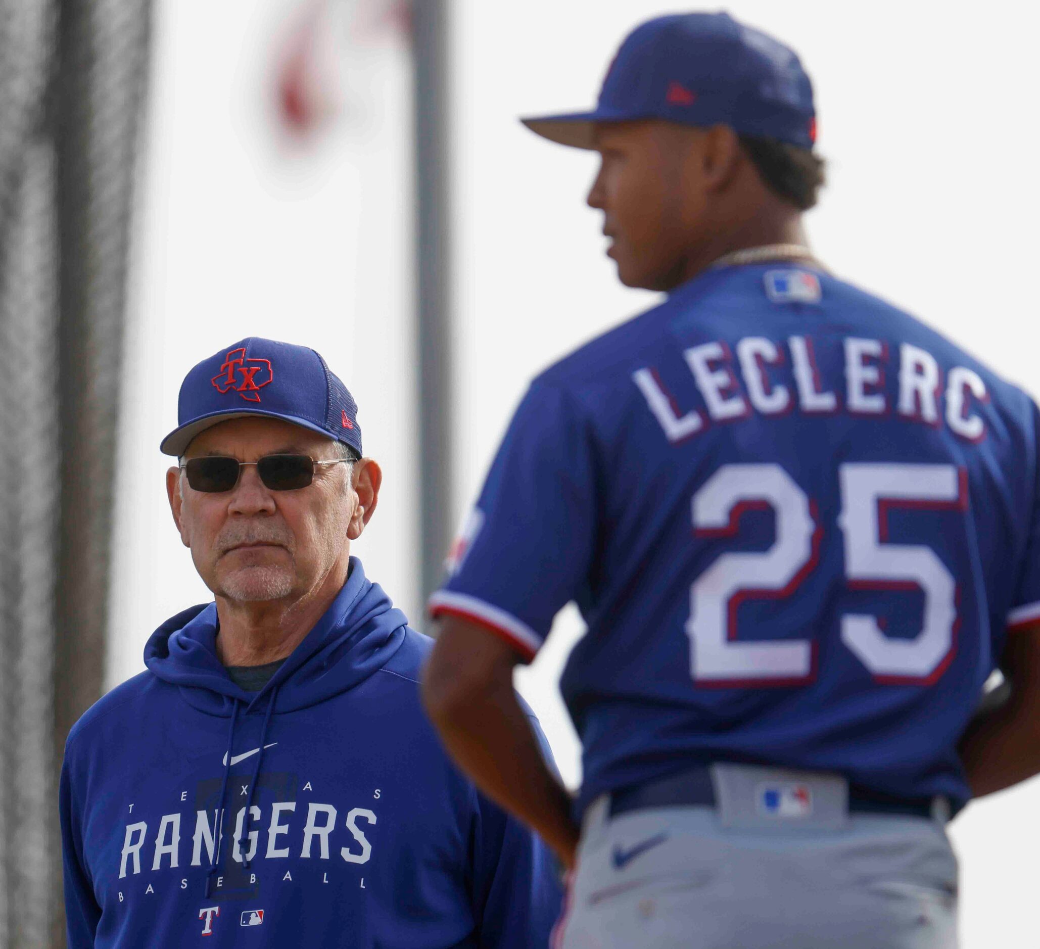 Texas Rangers manager Bruce Bochy, left, observes pitcher Jose Leclerc during spring...