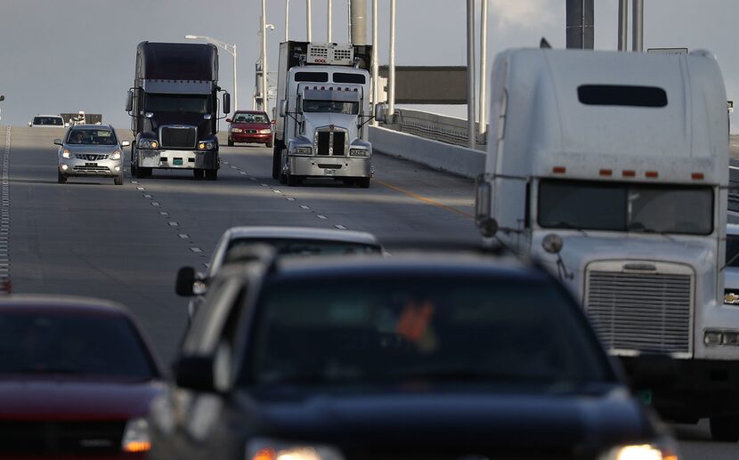 Tractor trailers roll along the highway  in Miami.