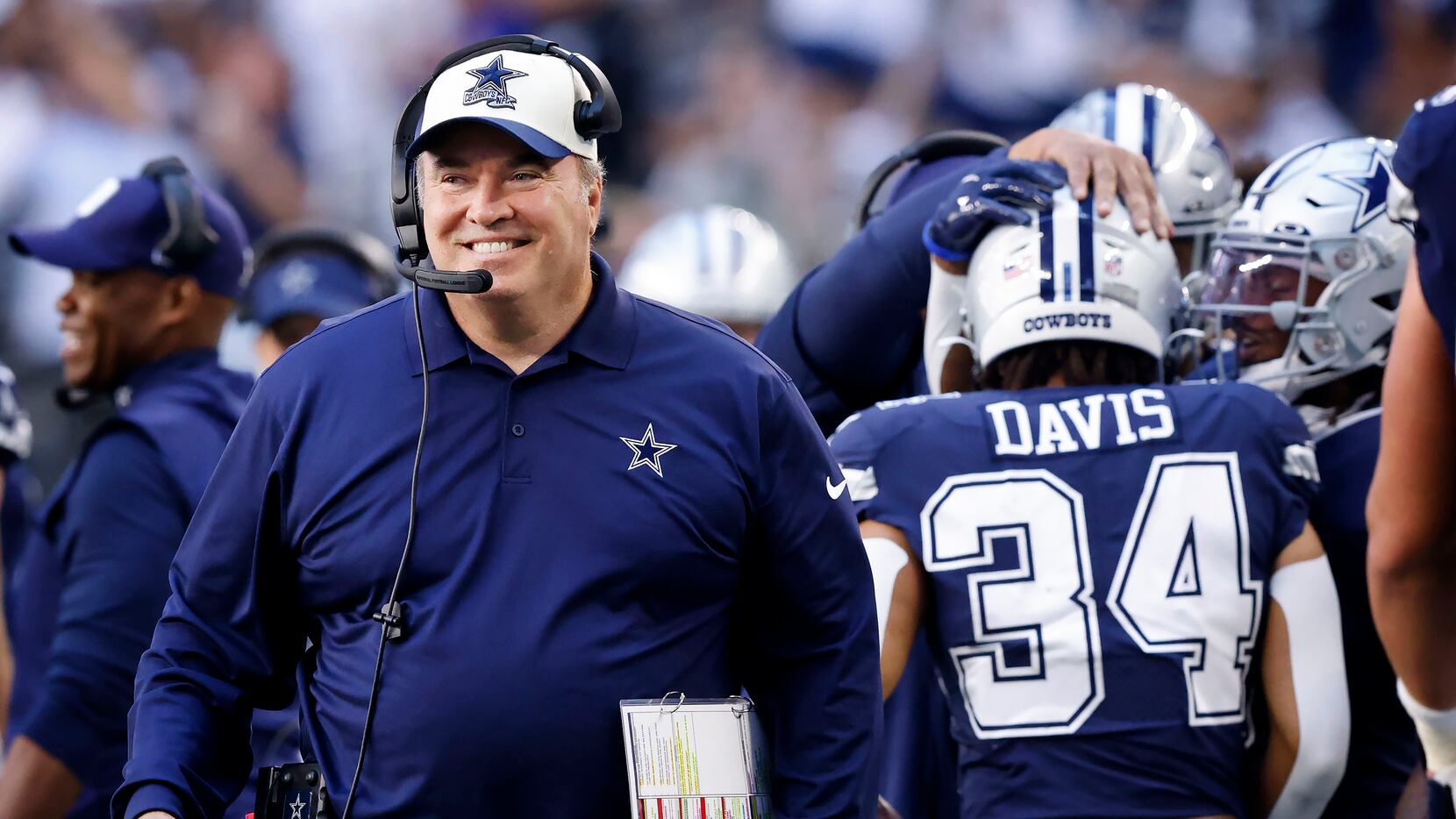 Dallas Cowboys head coach Mike McCarthy flashes a big smile after Malik Davis’s (34) first...