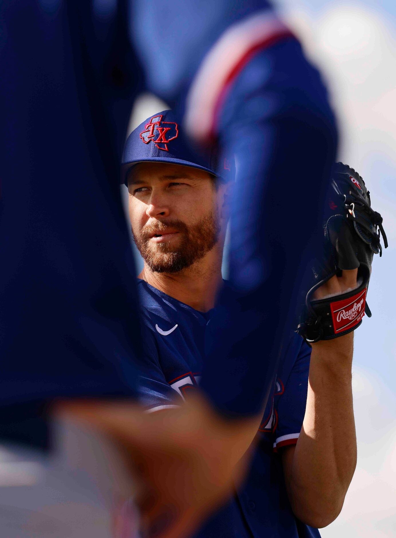 Texas Rangers pitcher Jacob deGrom warms up during a spring training workout at the team's...