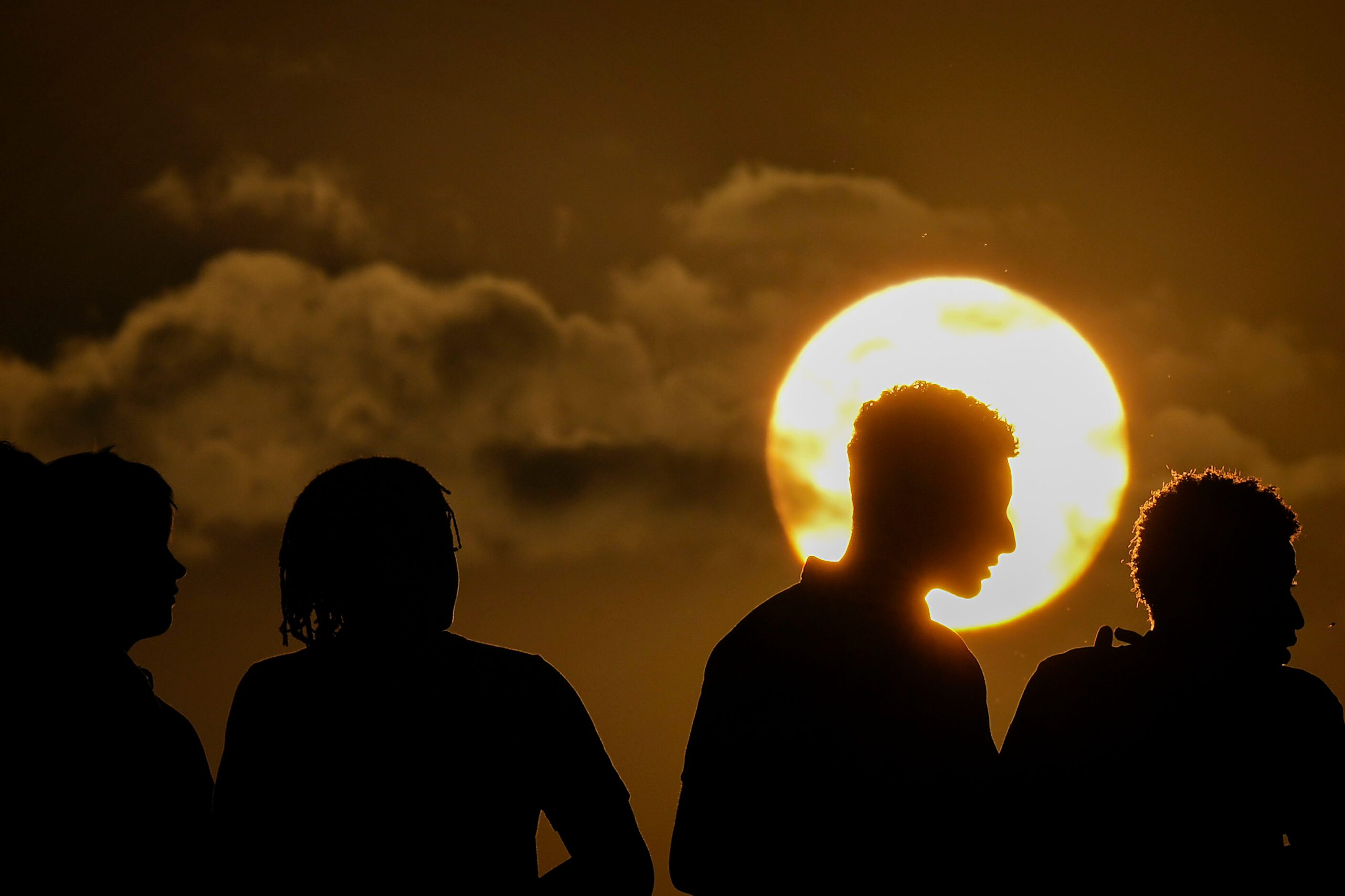 Denton Guyer fans watch as the sun sets during the first half of a high school football game...